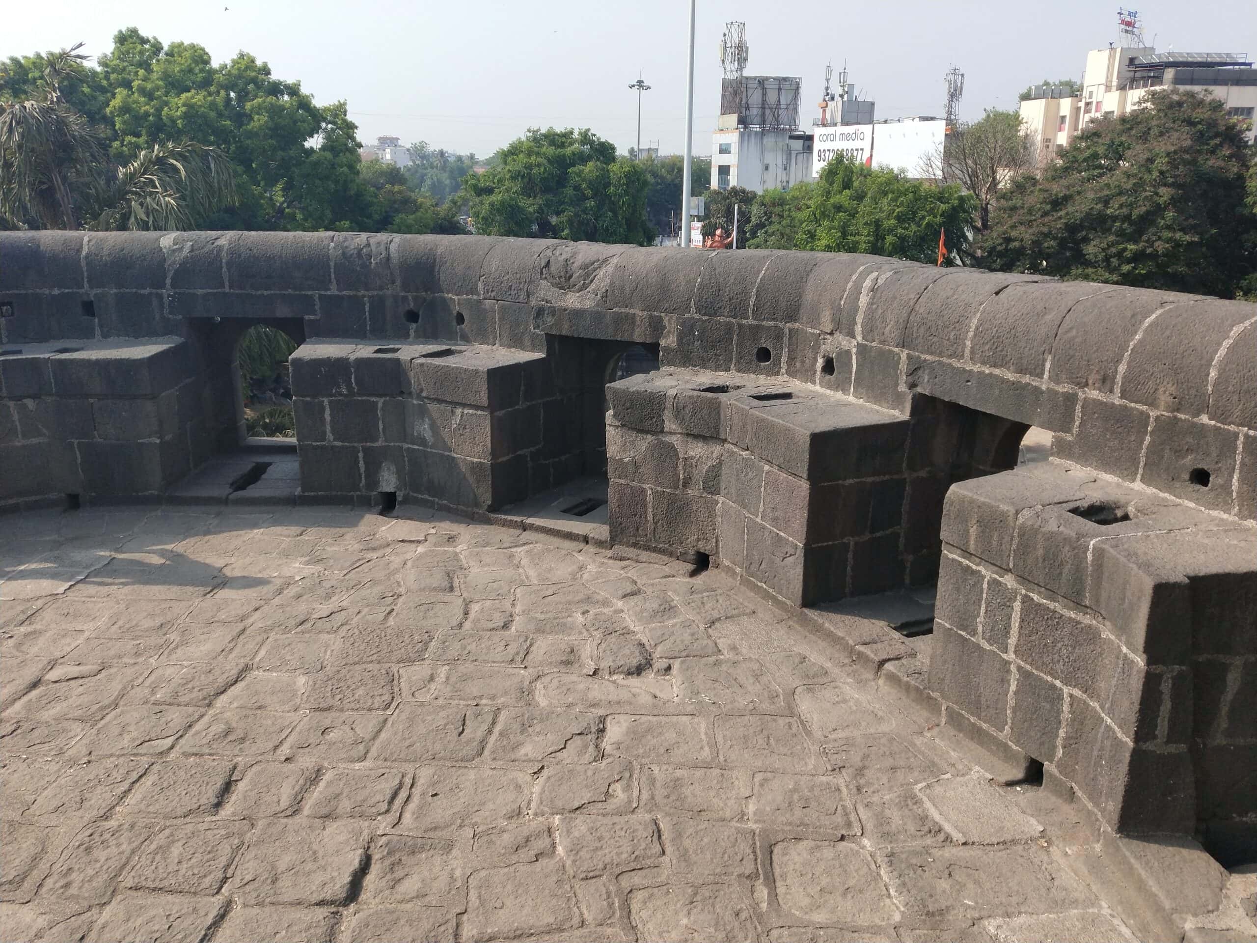 Fort wall showing window-like defense holes of Shaniwar Wada